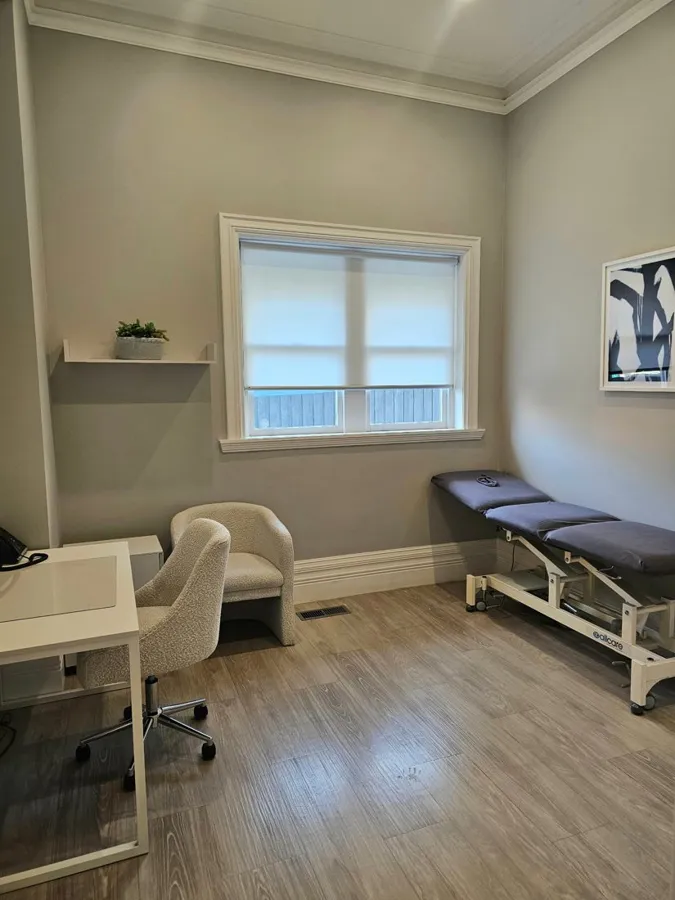 Consulting room with a treatment table, desk and client chair