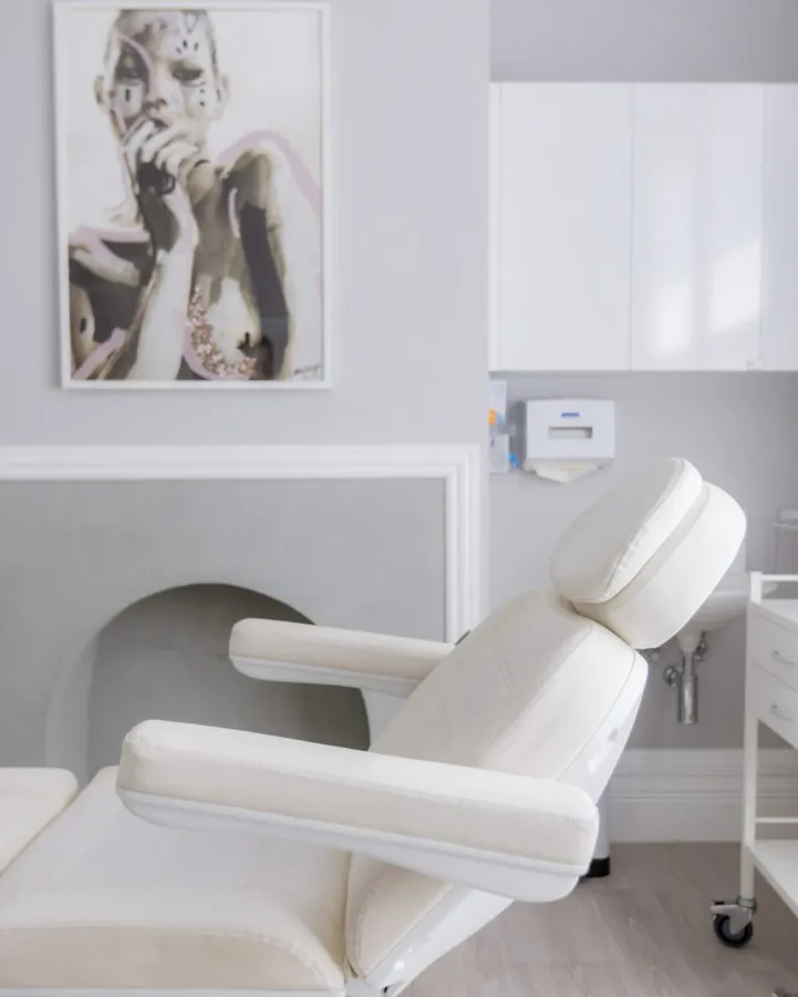 Bright treatment room with a white treatment chair